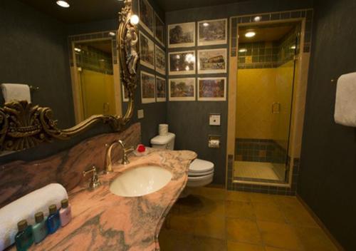 a bathroom with a sink and a toilet and a mirror at Madonna Inn in San Luis Obispo