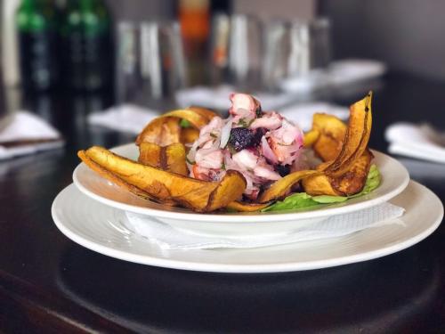 a plate of food with fries on a table at Hotel Plaza in Santiago
