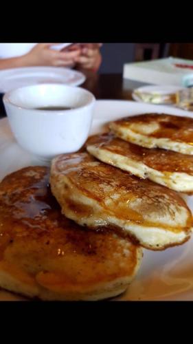 three pancakes on a plate on a table at Hotel Plaza in Santiago