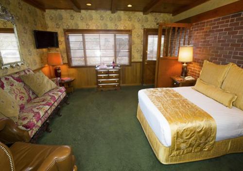 a bedroom with a large bed and a couch at Madonna Inn in San Luis Obispo