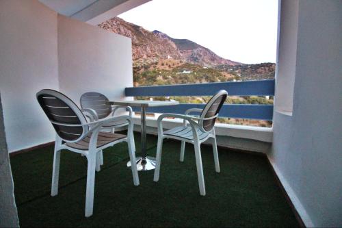 a table and chairs with a view of a mountain at Balcon Bleu in Chefchaouene