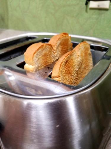 a group of bread in a pot with a burner at Super 8 by Wyndham New Cumberland in New Cumberland