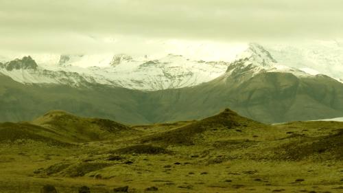 a mountain range with snow capped mountains in the distance at Guesthouse Kálfafellsstadur in Kálfafellsstaður