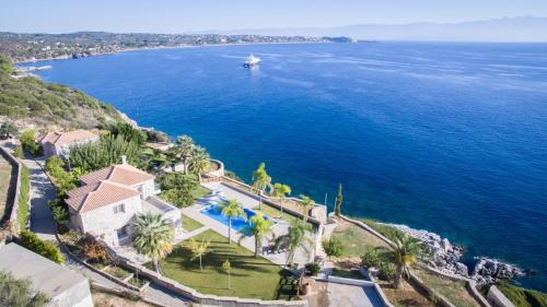 an aerial view of a house next to the ocean at Infinity Blue Villa in Koroni