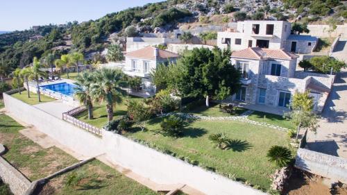 an aerial view of a house with a swimming pool at Infinity Blue Villa in Koroni