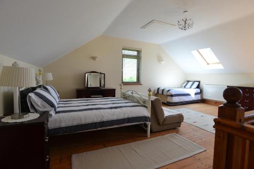 a bedroom with a bed and a couch and a tv at Penddaulwyn Uchaf Farm # Carmarthenshire in Nantgaredig