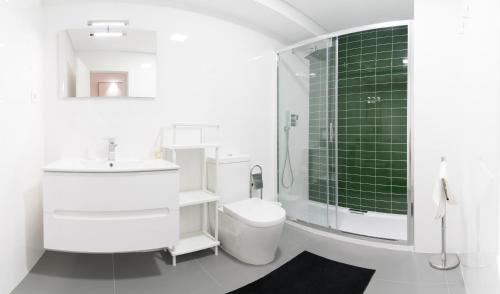 a bathroom with a toilet and a sink and a shower at Bracara Guest House "D. Pedro V" in Braga