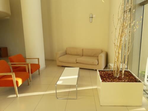 a living room with a couch and a table at San Alfonso del Mar Departamentos in Algarrobo
