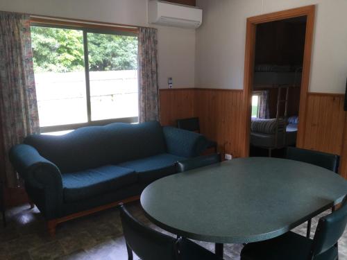 a living room with a couch and a table at A'Wangralea Caravan Park in Mallacoota