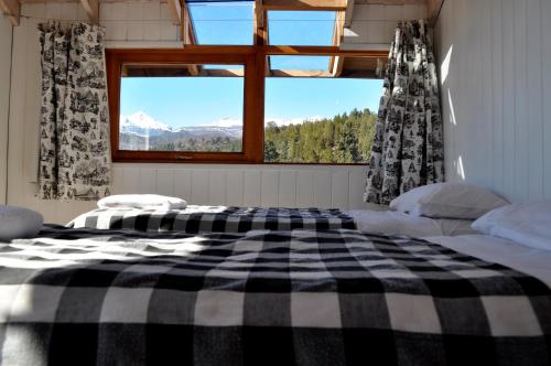 a bedroom with a black and white checkered bed at Casa Las Moras in San Martín de los Andes