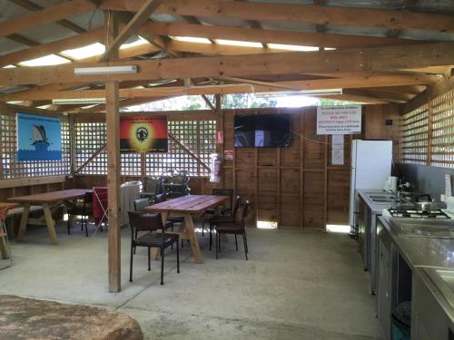 a kitchen and dining room with a table and chairs at A'Wangralea Caravan Park in Mallacoota