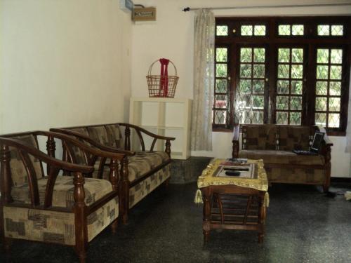 a living room with a couch and a table at Lodge in 611 in Kandy