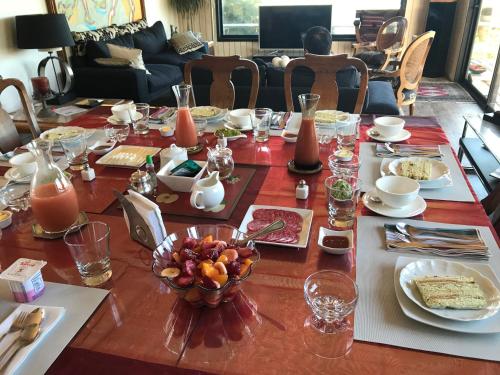 a dining room table with a table set with food at B&B Casa Las Brisas Matanzas in Matanzas