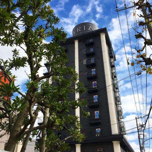 a tall building with a clock on top of it at Hotel Aria(Adult Only) in Chiba