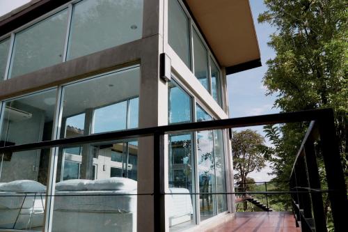 a glass door of a house at Mighty Mountain Thailand in Kaeng Krachan
