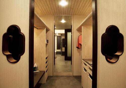 a hallway leading into a bathroom with a mirror at Baba Beach Club Natai Luxury Pool Villa Hotel by Sri panwa - SHA Plus in Natai Beach