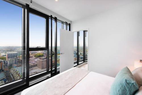a bedroom with white walls and large windows at FV by Peppers in Brisbane