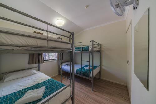 a bedroom with two bunk beds and a window at Capricorn Caves in Rockhampton