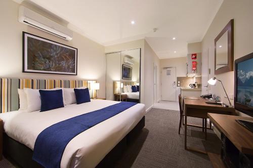 a hotel room with a large bed and a large window at Quest Whyalla in Whyalla