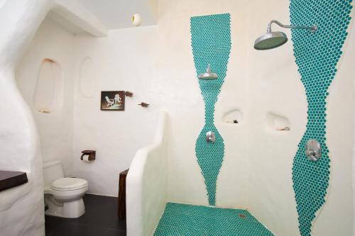 a bathroom with a shower with a blue floor at Koh Tao Cabana in Koh Tao