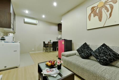 a living room with a couch and a table at iCheck inn Residence Sukhumvit 1 in Bangkok