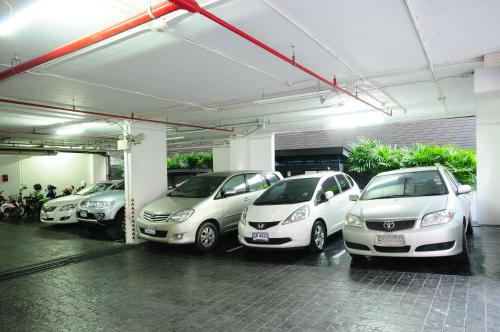 a group of cars parked in a parking lot at iCheck inn Residence Sukhumvit 1 in Bangkok