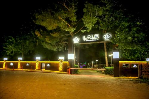 a lit up sign in front of a building at night at Lale Hotel in Sapanca