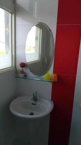 a bathroom with a sink and a mirror at Breadtree Homestay in Wujie
