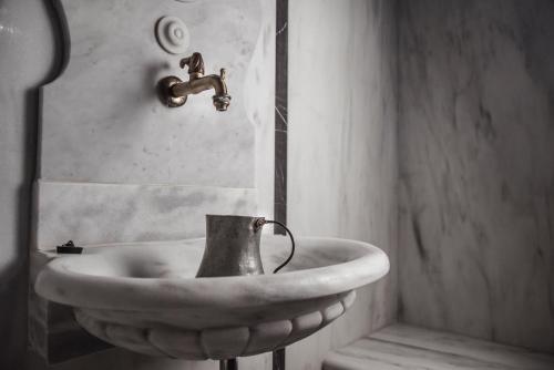 a sink in a bathroom with a faucet at Theofilos Paradise Boutique Hotel in Mytilini