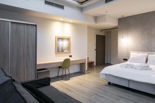 a hotel room with a bed and a desk at Superior One Boutique Hotel in Thessaloniki