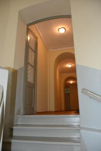 a view of a hallway with stairs and a mirror at Ferienwohnung "Schloss Kromlau" in Kromlau