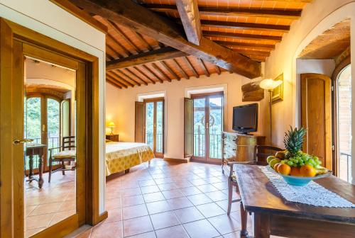 a room with a bed and a table with a bowl of fruit at Villaggio Albergo San Lorenzo e Santa Caterina in Pescia