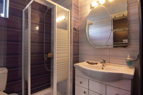 a bathroom with a sink and a mirror at Villa Irene & Villa Sylvia in Roumelí
