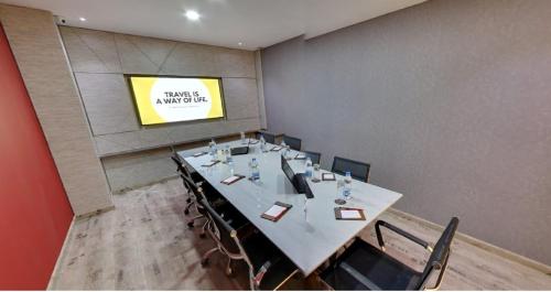 a conference room with a long table and chairs at Regenta Central Antarim Ahmedabad in Ahmedabad