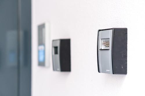 two switches on the side of a wall at Old Town Apartments in Kaufbeuren