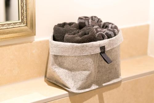 a bag of towels sitting on a counter next to a mirror at Old Town Apartments in Kaufbeuren