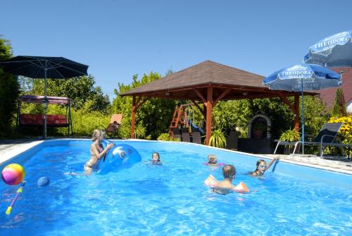 a group of children playing in a swimming pool at Marietta Apartman in Hévíz
