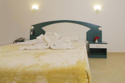 a bedroom with a bed with white towels on it at Golden Beach 1 Ras Sedr in Ras Sedr