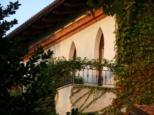 a building with a balcony with plants on it at B&B Selisa in Bene Vagienna