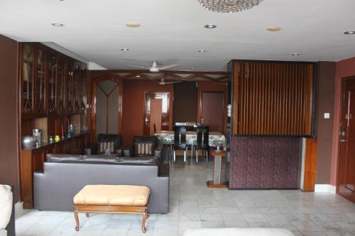 a living room with a couch and a table at Service Apartments, Park Street, Calcutta in Kolkata