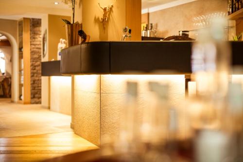 a kitchen with a counter with lights on it at Hotel Weingut Innerleiterhof in Schenna