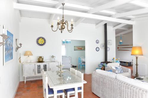 a living room with a table and a couch at Casa na Areia in Lavos