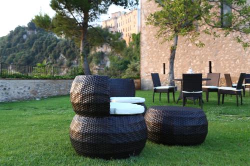 a group of tires sitting in the grass with a table and chairs at Monastero Di Sant'Erasmo in Veroli