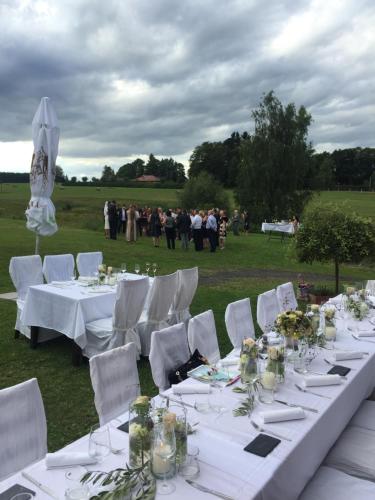 a table with white tables and chairs and a crowd of people at Villa Rozmaryn & Gourmet in Mariánské Lázně