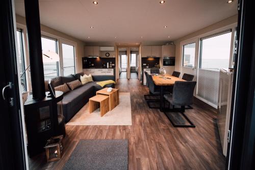 a living room with a couch and a table at Goitzsche Resort in Bitterfeld