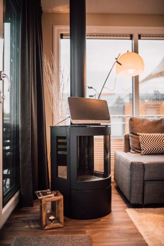 a living room with a laptop on top of a fireplace at Goitzsche Resort in Bitterfeld