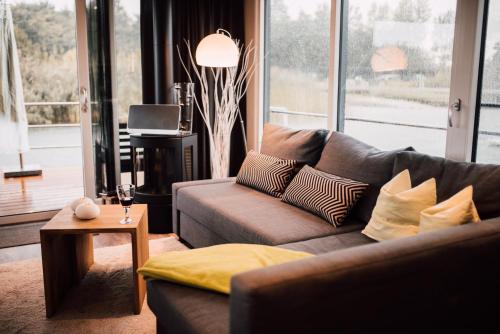 a living room with a couch and a table at Goitzsche Resort in Bitterfeld