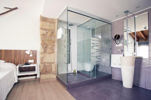 a bathroom with a shower, sink, and toilet at Hotel Restaurante Masía la Torre in Mora de Rubielos