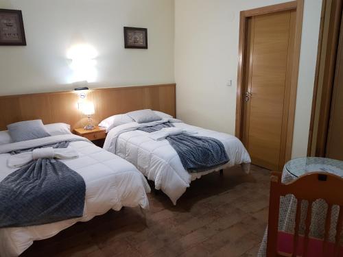 Ένα ή περισσότερα κρεβάτια σε δωμάτιο στο Hostal Ponte Dos Santos