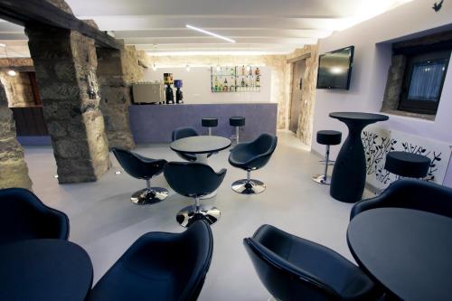 a salon with chairs and a table in a room at Hotel Restaurante Masía la Torre in Mora de Rubielos